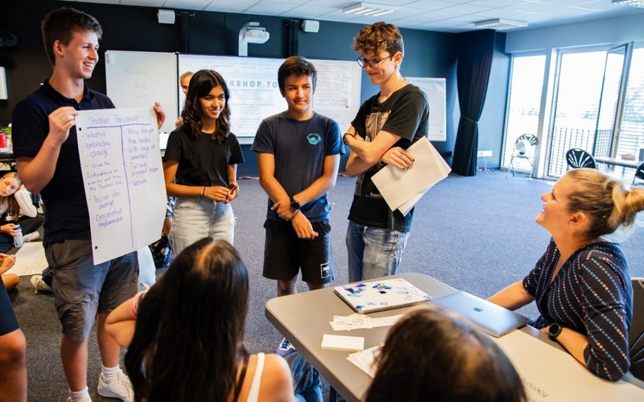 Academic Counsellor, Ms Edmunds, joining the listening students with some questions as the Student Parliament team present their ideas. 