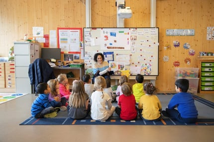 Teachers telling a story to a group of young ISL Students